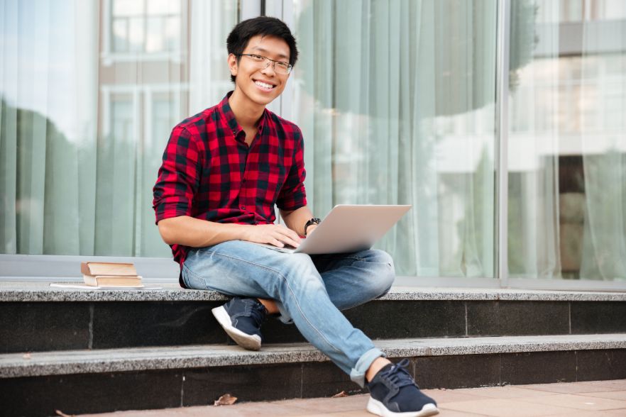 Teenager Using Laptop for Economics Tuition