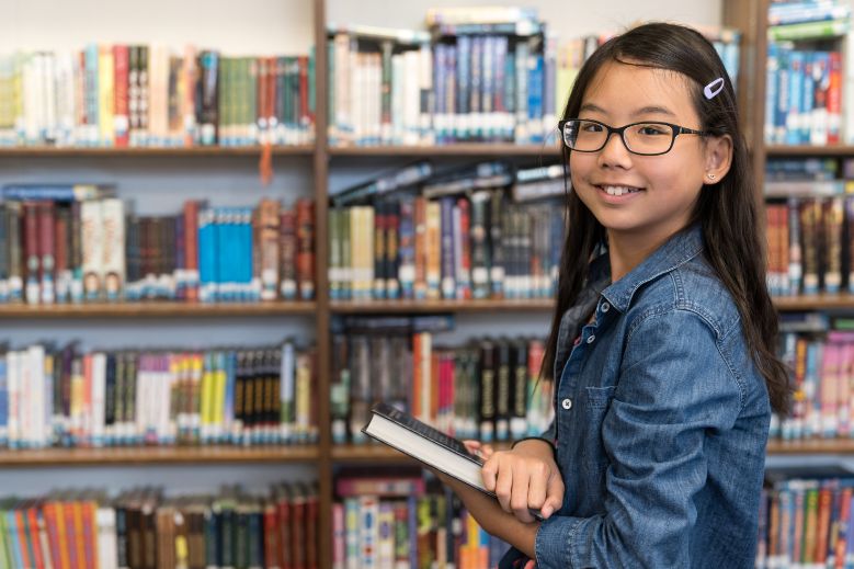 Teenage girl having English Tuition in the Library